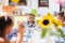 Small children sitting at the table outdoors on garden party in summer, eating.