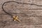 Small Christian golden cross on rustic wooden background