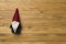 Small Christmas dwarf on wooden background, top view