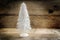 small christmas tree from white flocked wire against a rustic wooden background with large copy space
