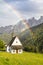 Small church in Alps under the rainbow