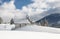 Small church in beautiful landscape of snowy alps. Winter in Austria. Fresh fallen snow on mountain with firs and small church.