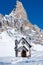 Small church in front of peak in Passo Rolle