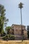 A small church near a palm tree in a park on a Villa Doria-Pamphili in Rome, Italy