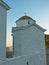 Small church at sunset on a top of a cliff above Skopelos bay and harbor, Skopelos island