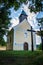 Small church surrounded by lush green trees. Calvary over Kremnica town in Slovakia.