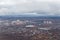 A small city from the height of the aircraft. High-rise buildings near the lake. View of the earth from an airplane.