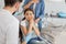 Small client with dentist and pain in the teeth sitting in dental chair while mother standing near her for support