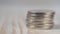 Small coins fall on a pile. Macro view