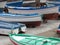 Small colored boats to earth in a port in Italy.