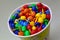Small colored toys in a bucket of popcorn
