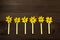 Small, colorful birthday candles Small, coSmall, yellow, birthday candles arranged in a row with yellow flowers like flames