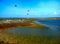 Small colorful lagoon in Sri Lanka with kites in background