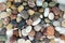 Small colorful pebbles background, simplicity, daylight, stones, white, green, grey, red, orange,