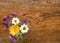 Small colourful posy of flowers on a wooden table.