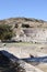 Small and cosy ancient roman theatre with the ruins of temple with row of columns in archaeological site Pergamon in Turkey