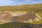 Small Crater Rising out of the Shadows in a Volcanic Landscape