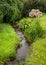 Small creek, green meadow Normandy France in summer