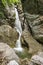 Small creek with many waterfalls in the middle of forest