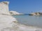 Small creek with white moon rocks to Milo in the Cyclade Islands in Greece .