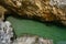 Small croatian shore cove hidden between steep cliffs with clear azure water