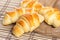 Small croissants on wooden table