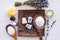 Small cube shape bathroom bath fizzies on wood tray, surrounded by ingredients.