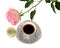 Small cup of aromatic black coffee, pistachio honey-souffle and beautiful pink rose on white background