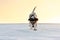 Small cute 9 years old frozen Jack Russell Terrier dog is going over a snowy meadow in winter