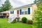 Small cute mobile house. View of the lawn porch