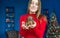 Small cute puppy of dachshund in hands of a young woman on Christmas background. Selective fokus in puppy.