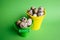 Small decorative buckets filled quail eggs on the green background