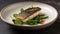 A small, delicate dish of grilled miso-glazed fish with a simple garnish of green salad.