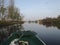 Small dingy sailing through Dutch canals on summer morning