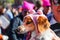 Small dog in Pink hat yawning surrounded by people in hats at Womens march in Tulsa Oklahoma 1-20-2017