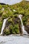 A small double waterfall on the way to Franz Josef Glacier. South Island, New Zealand