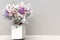 Small dried colorful flower on a vase with couple lover