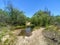 Small dusty trails with little water stream river in the valley