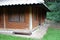 Small Earthen Brick Cabin with Wood Shutters