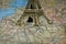 Small Eiffel tower Paris souvenir closeup on map