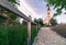 Small eighteen-century christian church in the golden hour with a wooden railing in front. Old Saint Ignatius church in