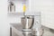 Small Electric Kitchen Appliances. Modern silver kitchen stand mixer in light cozy confectionery. A closeup of Multi