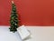 Small elegant Christmas tree with a white ajar gift box