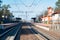 A small empty railway station, iron track going into the distance.