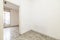 Small empty room of a house with terrazzo floors with black dots and exit