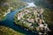 A small European town on a mountain with a river, view from the top.