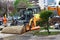 Small excavator next to roadwork