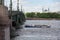 Small excursion ship just sailed under the Troitskiy Trinity Bridge on a spring sunny day