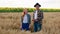 Small family business concept one couple in the middle of wheat field and sunflowers ana the field full of harvest