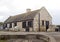 A small family enjoy coffee at the shop and visitor centre at the beautiful Ballintoy harbor on the North Coast of County Antrim i